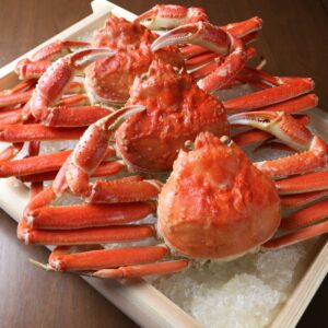 A tray of cooked crabs on ice on a table